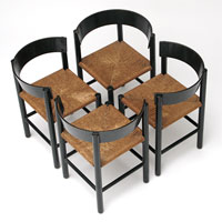 A set of 4 raised grain ebonized oak chairs designed by Lassen Mogens